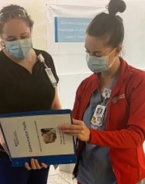 Sarah Gendreau, left, talks with her nursing colleague Katelyn Bushey at Mass. General.