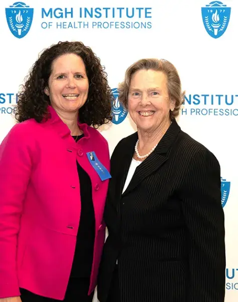 Two women standing and smiling
