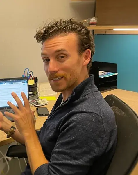 man talks at desk