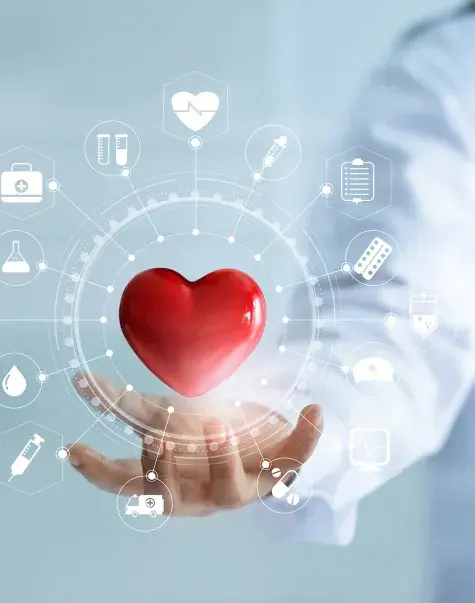 red heart floats above the hand of someone wearing a white lab coat